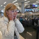 Traveler Shana Schiffer of Chicago reacts after receiving a missing Christmas bag from the Southwest Airlines baggage claim area at Salt Lake City International Airport, Thursday, Dec. 29, 2022, in Salt Lake City.