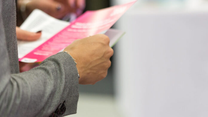 girl holding flyers